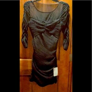 NWT. BCBG little black dress, size small. Thin black material with nude lining.